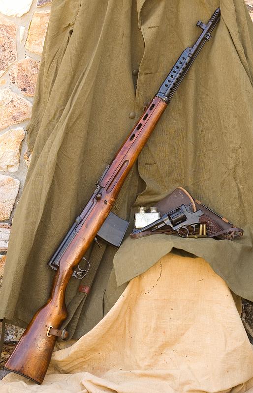 a-0971.jpg - Russian weapons:  SVT-40 rifle manufactured in 1940.  The markings indicate that it was captured by Finland during the Winter War.  The revolver is an 1895 Nagant revolver manufactured in 1908.  This was the primary handgun of Russian forces during World War I and continued in production and service with the Soviets through the end of World War II.