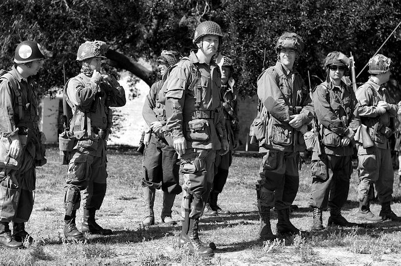 IMGP0528RS.JPG - American paratroopers in formation for the flag raising at the beginning of the reenactment.  It is important to remember that all the men photographed here are merely playing a part, every "soldier" of every nation represented saluted when the Stars and Stripes was raised.