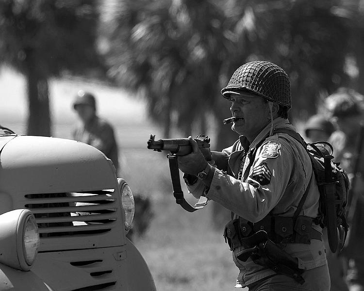IMGP0811RS.JPG - Another of my wife's shots with the K100d.  American Sergeant with M1 Rifle advancing past the German's truck.